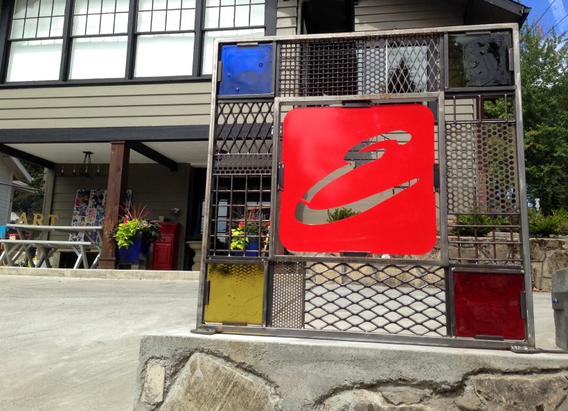 sign for a home business, Camas, WA 8"x8"x1" Blenko glass slabs are mounted in the four corners. The mounting bracket on the right is for installation. 3 brackets with 5 bolt holes.